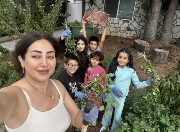 Merrymoon’s owner and children gathering garden plants together