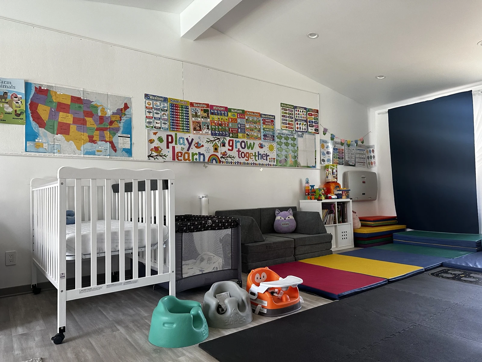 Merrymoon indoor space with ride-on toys and bright play mats