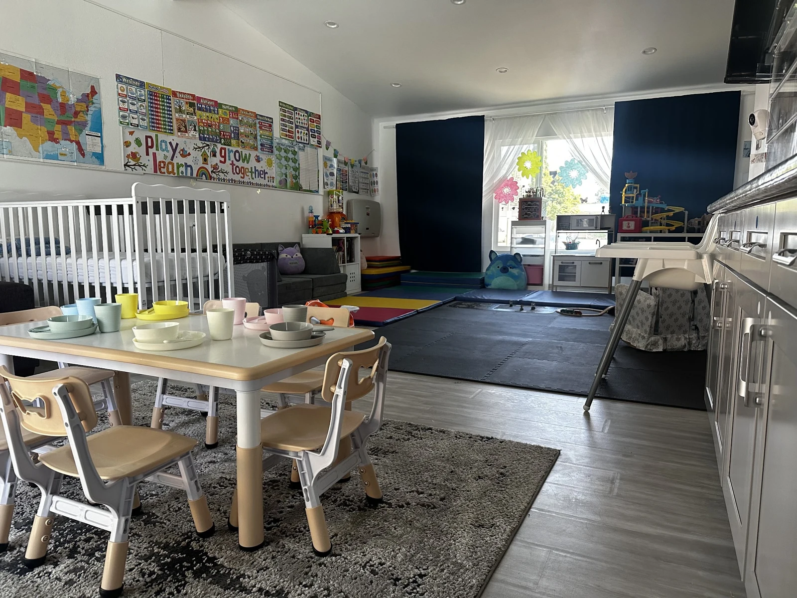 Merrymoon classroom with child-sized tables, colorful learning mats, and play areas
