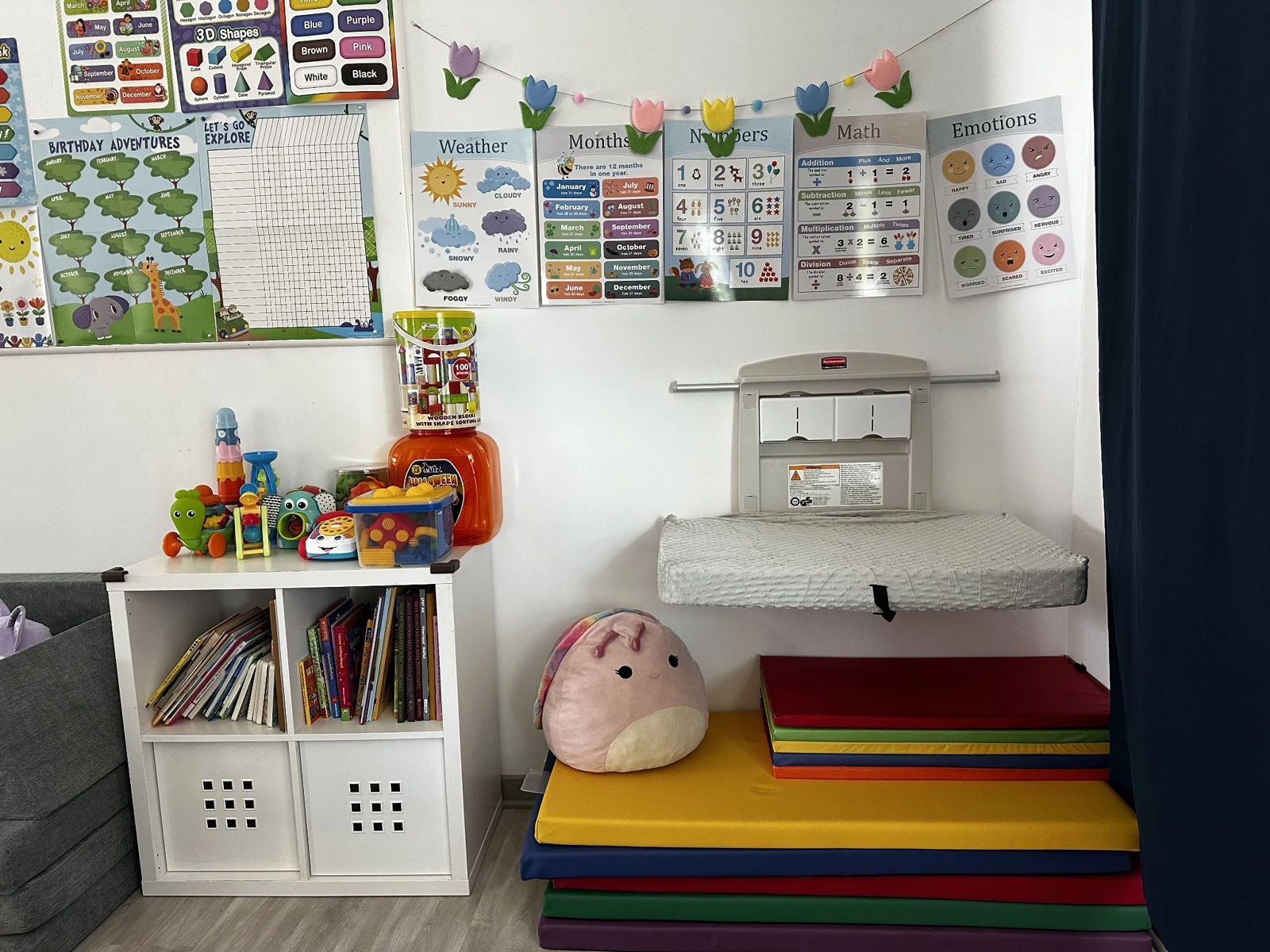 Books, toys, rainbow mats, and learning displays at Merrymoon